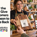 A shopkeeper hands a customer a wooden cutting board and care card while a phone shows the matching online care guide, with the blog title and Muskoka Graphics logo.